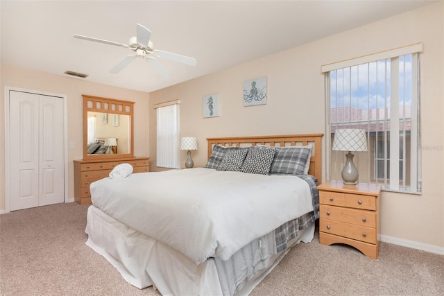 carpeted bedroom featuring baseboards and ceiling fan