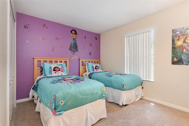 bedroom featuring carpet floors and baseboards