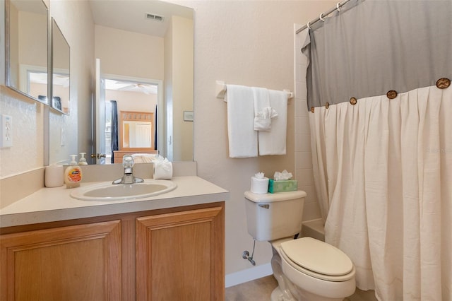 full bathroom featuring toilet, vanity, and a ceiling fan