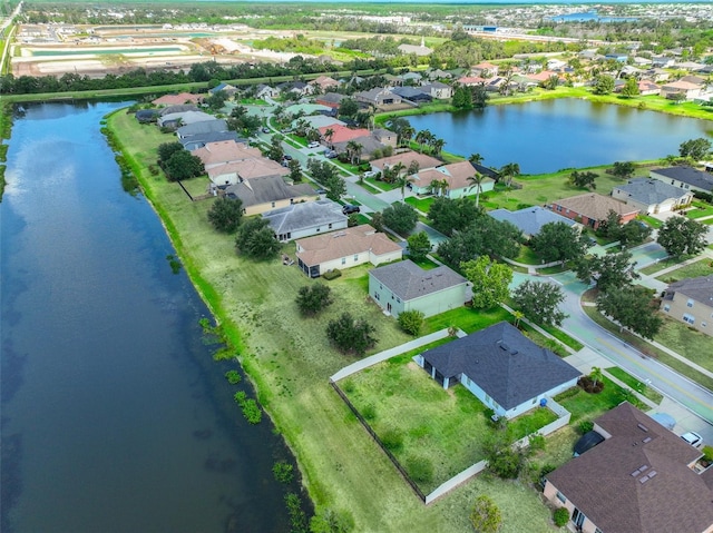 drone / aerial view with a water view and a residential view