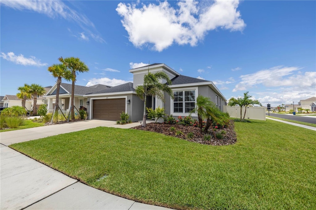 5924 Fieldmoor Ct, Palmetto, FL 34221 - ranch-style house featuring fence, an attached garage, concrete driveway, stucco siding, and a front lawn