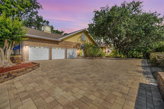 2769 St Andrews Blvd, Tarpon Springs, FL 34688 - view of front of home featuring an attached garage, driveway, and brick siding