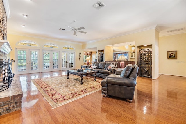 2769 St Andrews Blvd, Tarpon Springs, FL 34688 - living room featuring ornamental molding, french doors, a ceiling fan, and wood finished floors
