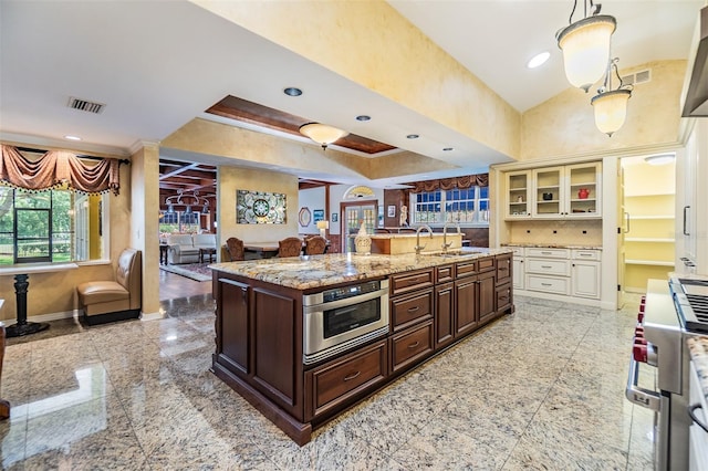 2769 St Andrews Blvd, Tarpon Springs, FL 34688 - kitchen featuring granite tiled floors, open floor plan, appliances with stainless steel finishes, dark brown cabinetry, and a sink