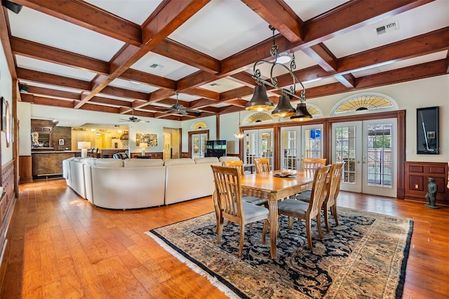 2769 St Andrews Blvd, Tarpon Springs, FL 34688 - dining room featuring coffered ceiling, french doors, light wood-style flooring, beamed ceiling, and ceiling fan
