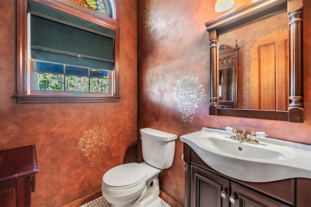 2769 St Andrews Blvd, Tarpon Springs, FL 34688 - bathroom with toilet, baseboards, vanity, and tile patterned floors