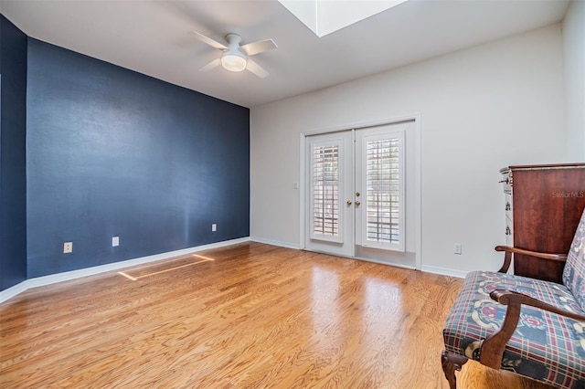 2769 St Andrews Blvd, Tarpon Springs, FL 34688 - sitting room featuring wood finished floors, ceiling fan, french doors, and baseboards