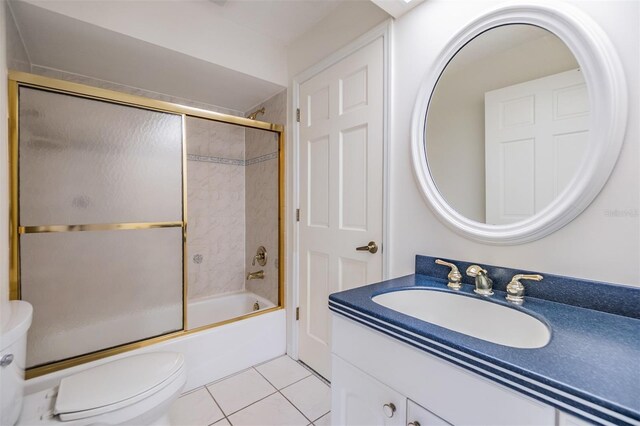 2769 St Andrews Blvd, Tarpon Springs, FL 34688 - full bathroom featuring toilet, tile patterned floors, vanity, and enclosed tub / shower combo