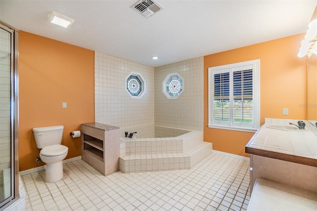 2769 St Andrews Blvd, Tarpon Springs, FL 34688 - full bathroom featuring toilet, tile patterned floors, baseboards, a garden tub, and vanity