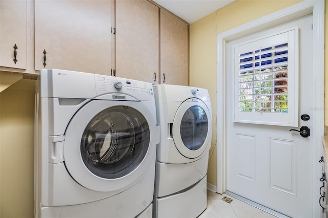 2769 St Andrews Blvd, Tarpon Springs, FL 34688 - laundry room with washing machine and clothes dryer, cabinet space, and light tile patterned floors