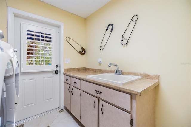 2769 St Andrews Blvd, Tarpon Springs, FL 34688 - laundry area with a sink and light tile patterned floors