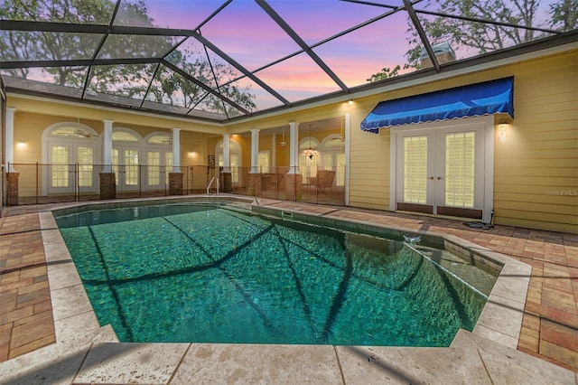2769 St Andrews Blvd, Tarpon Springs, FL 34688 - pool at dusk featuring french doors, an outdoor pool, and a patio