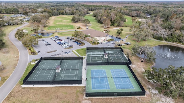 2769 St Andrews Blvd, Tarpon Springs, FL 34688 - drone / aerial view of a golf club, a nearby body of water, and a heavily wooded area