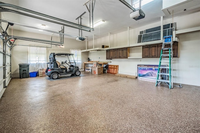 2769 St Andrews Blvd, Tarpon Springs, FL 34688 - garage featuring a garage door opener and baseboards