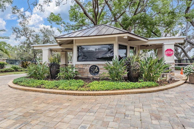 2769 St Andrews Blvd, Tarpon Springs, FL 34688 - view of side of property featuring stone siding and stucco siding