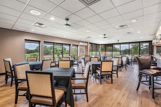 2769 St Andrews Blvd, Tarpon Springs, FL 34688 - dining space with plenty of natural light, light wood finished floors, a wall mounted AC, a paneled ceiling, and recessed lighting