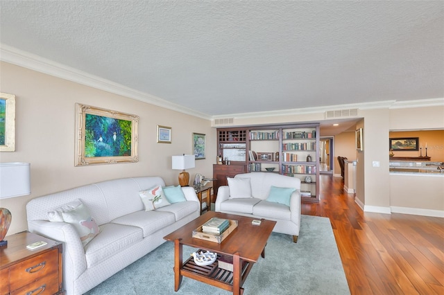 5701 Mariner St Unit 701, Tampa, FL 33609 - living room with ornamental molding, wood finished floors, baseboards, and a textured ceiling