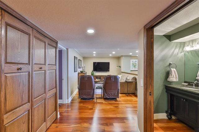 5701 Mariner St Unit 701, Tampa, FL 33609 - home office featuring light wood-type flooring, a sink, baseboards, and recessed lighting