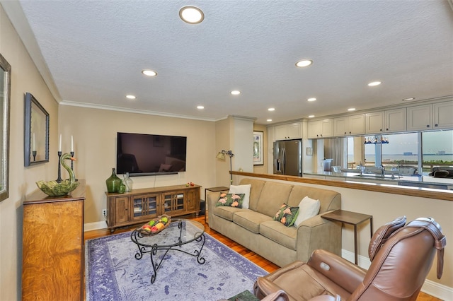 5701 Mariner St Unit 701, Tampa, FL 33609 - living area featuring wood finished floors, recessed lighting, baseboards, a textured ceiling, and ornamental molding