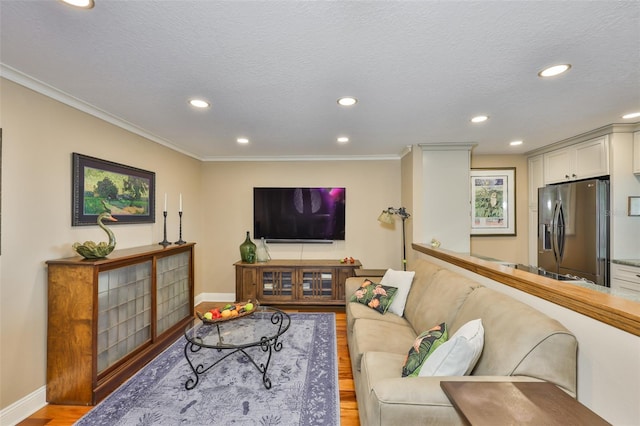 5701 Mariner St Unit 701, Tampa, FL 33609 - living room with light wood-style flooring, recessed lighting, baseboards, crown molding, and a textured ceiling
