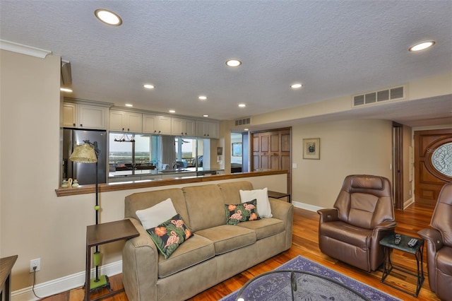 5701 Mariner St Unit 701, Tampa, FL 33609 - living area with recessed lighting, a textured ceiling, baseboards, and wood finished floors