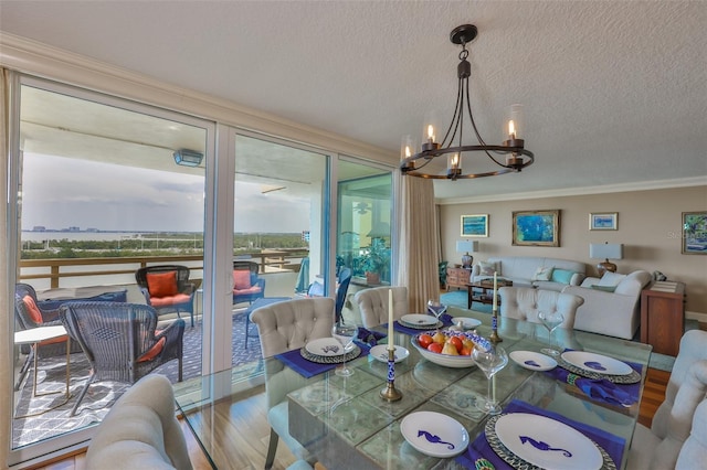 5701 Mariner St Unit 701, Tampa, FL 33609 - dining space featuring a chandelier, crown molding, wood finished floors, and a textured ceiling
