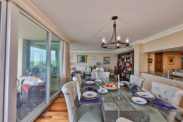 5701 Mariner St Unit 701, Tampa, FL 33609 - dining room featuring a chandelier, crown molding, and wood finished floors
