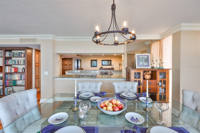 5701 Mariner St Unit 701, Tampa, FL 33609 - dining room with crown molding, a chandelier, and a textured ceiling
