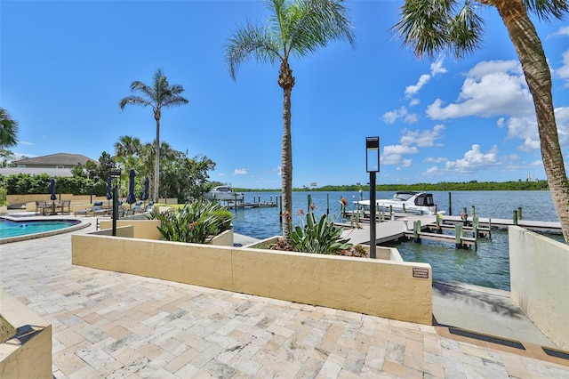 5701 Mariner St Unit 701, Tampa, FL 33609 - dock featuring a water view, a patio, and a swimming pool