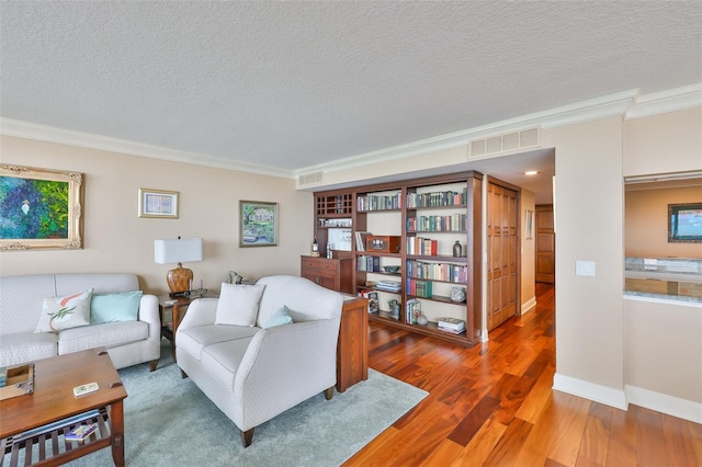 5701 Mariner St Unit 701, Tampa, FL 33609 - living area with crown molding, wood finished floors, a textured ceiling, and baseboards