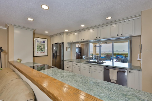 5701 Mariner St Unit 701, Tampa, FL 33609 - kitchen featuring fridge with ice dispenser, dishwasher, a sink, recessed lighting, and a textured ceiling