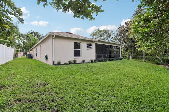 13813 Sigler St, Riverview, FL 33579 - back of property featuring a yard, a sunroom, fence, and stucco siding