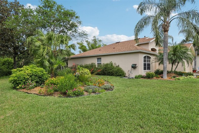 13813 Sigler St, Riverview, FL 33579 - view of side of property with stucco siding and a lawn