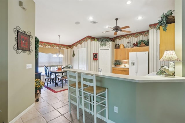 13813 Sigler St, Riverview, FL 33579 - kitchen with a peninsula, white fridge with ice dispenser, visible vents, ceiling fan, and light countertops