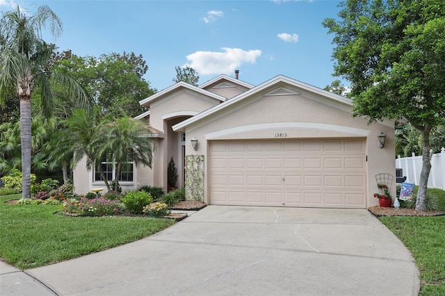 13813 Sigler St, Riverview, FL 33579 - single story home featuring a garage, stucco siding, fence, concrete driveway, and a front lawn
