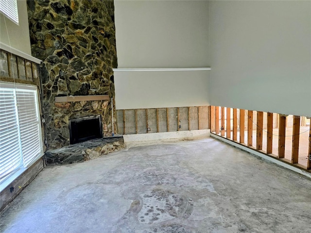 unfurnished living room featuring unfinished concrete flooring and a fireplace