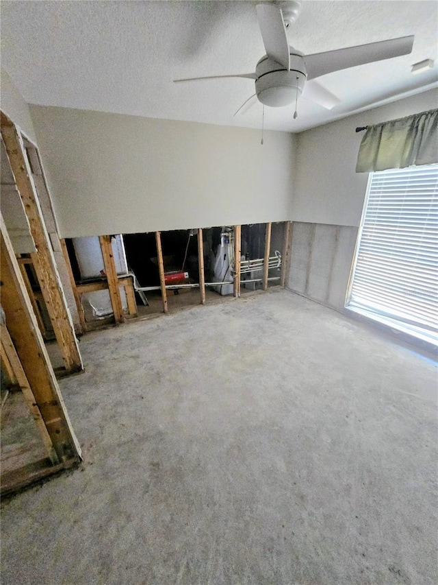 unfurnished room with ceiling fan and carpet flooring