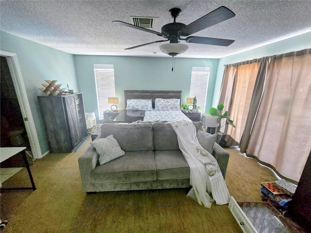 bedroom with a textured ceiling and ceiling fan