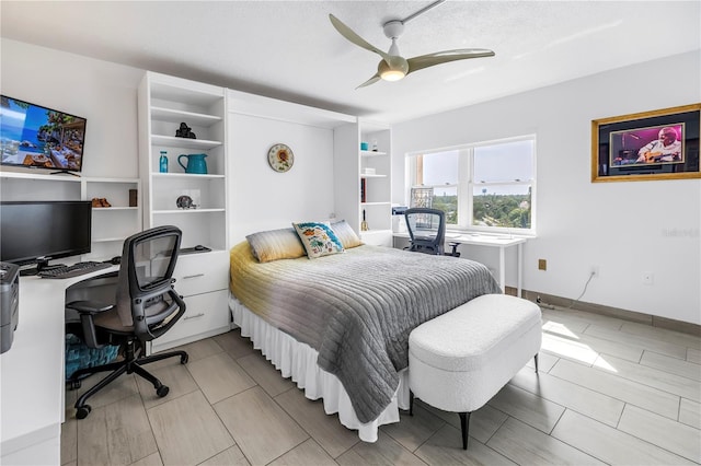 bedroom with an office area and ceiling fan