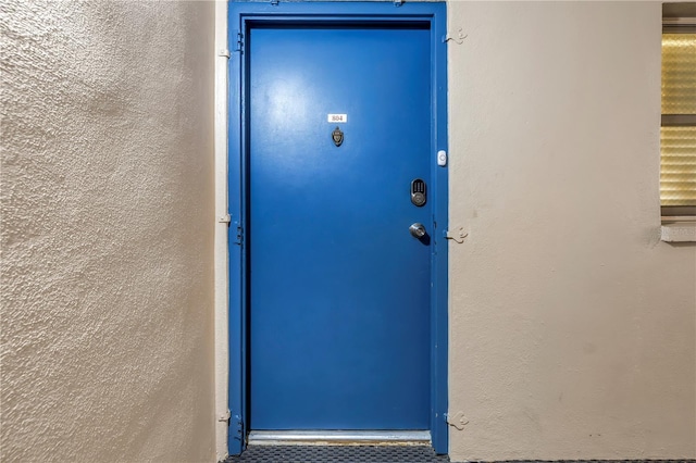 entrance to property with stucco siding