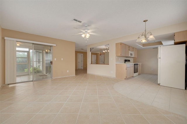 unfurnished living room with light tile patterned floors, a chandelier, a ceiling fan, and baseboards