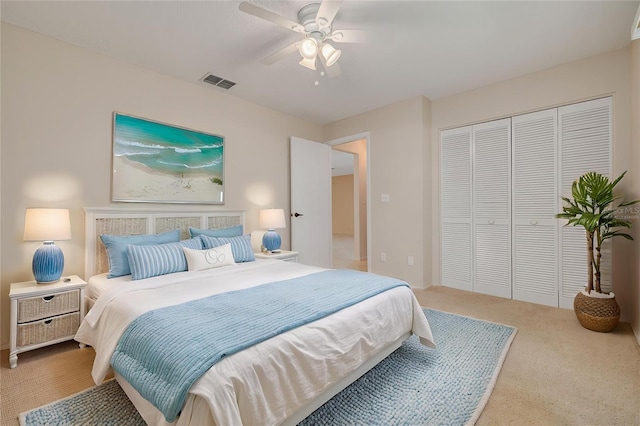 carpeted bedroom with a closet and a ceiling fan