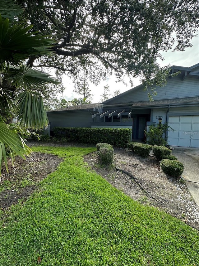 135 Pinewinds Blvd, Oldsmar, FL 34677 - view of yard featuring an attached garage