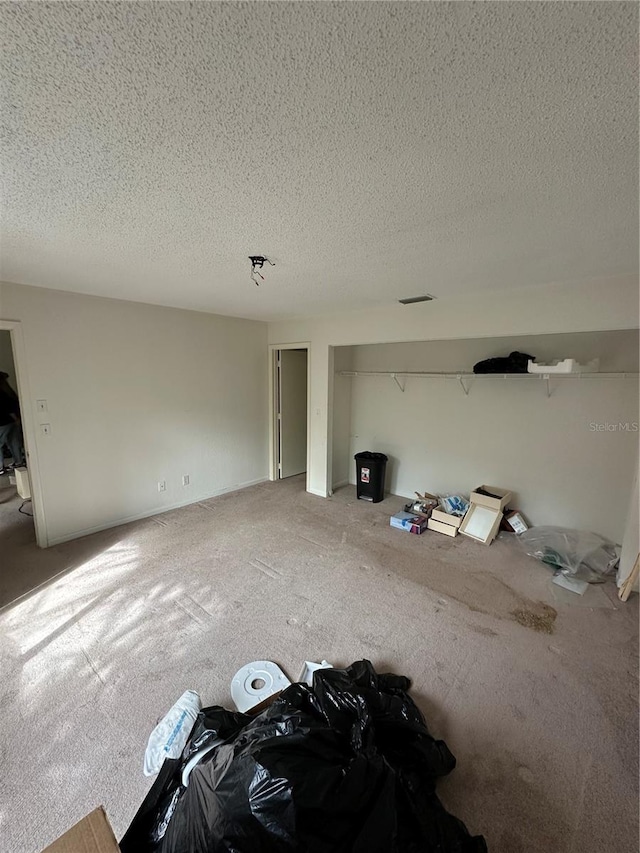 135 Pinewinds Blvd, Oldsmar, FL 34677 - unfurnished living room featuring carpet flooring and a textured ceiling