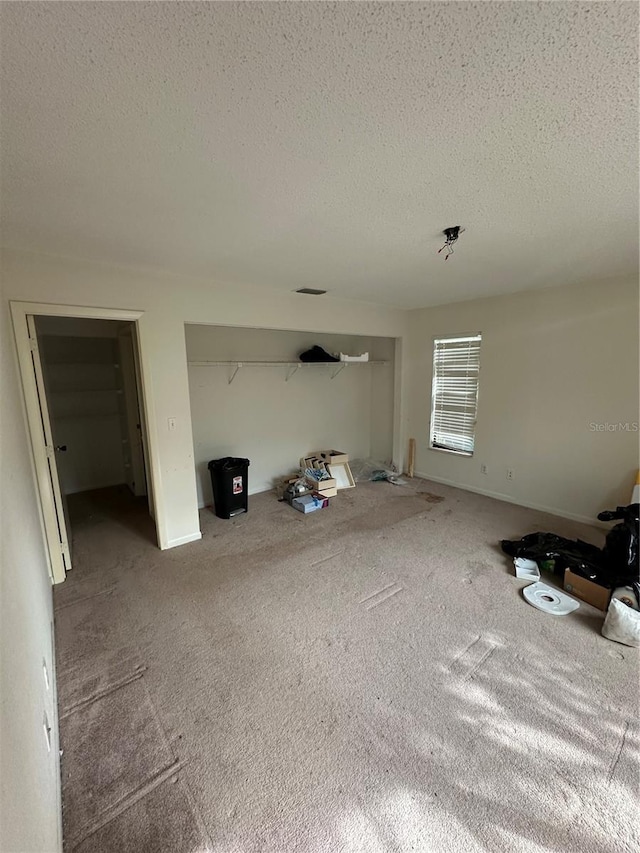 135 Pinewinds Blvd, Oldsmar, FL 34677 - unfurnished living room with a textured ceiling and carpet