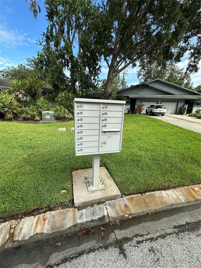 135 Pinewinds Blvd, Oldsmar, FL 34677 - view of property's community featuring mail area, a yard, and a garage