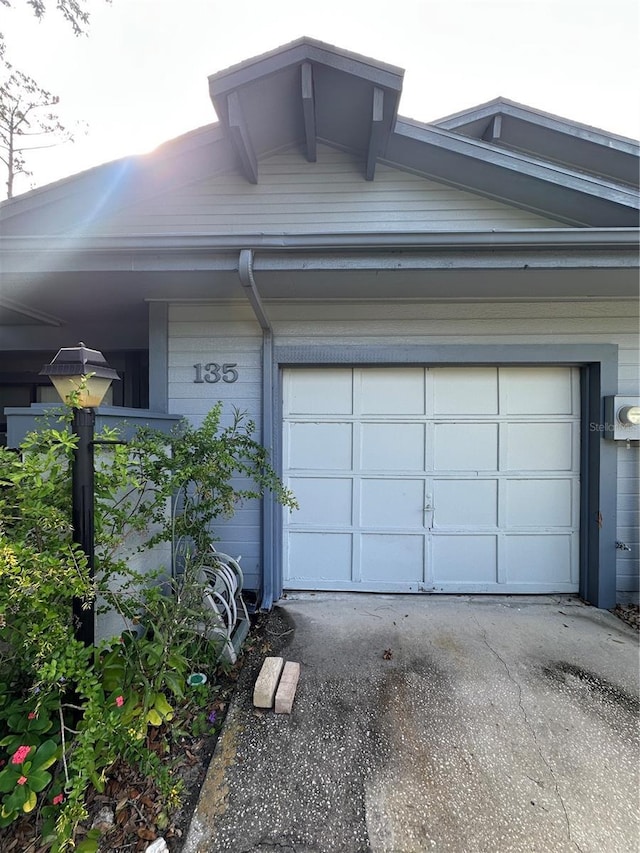 135 Pinewinds Blvd, Oldsmar, FL 34677 - garage with asphalt driveway