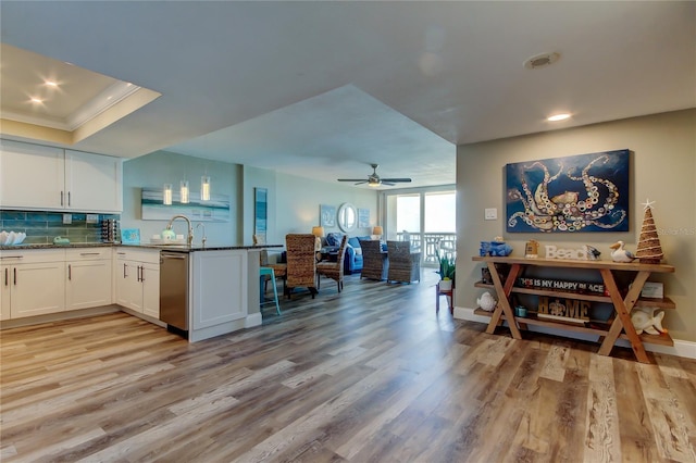 400 Island Way Unit 1709, Clearwater Beach, FL 33767 - kitchen with dishwasher, white cabinets, light wood-type flooring, recessed lighting, and a peninsula