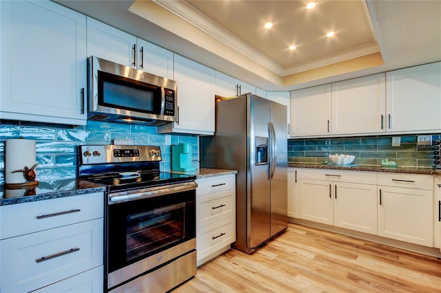 400 Island Way Unit 1709, Clearwater Beach, FL 33767 - kitchen with stainless steel appliances, ornamental molding, dark stone countertops, white cabinetry, and recessed lighting