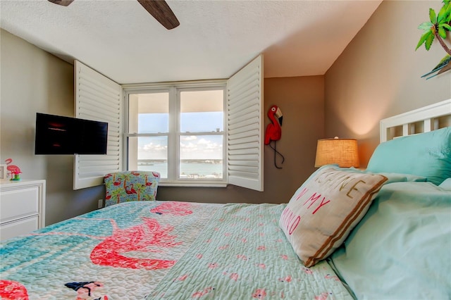 400 Island Way Unit 1709, Clearwater Beach, FL 33767 - bedroom featuring a ceiling fan and a textured ceiling
